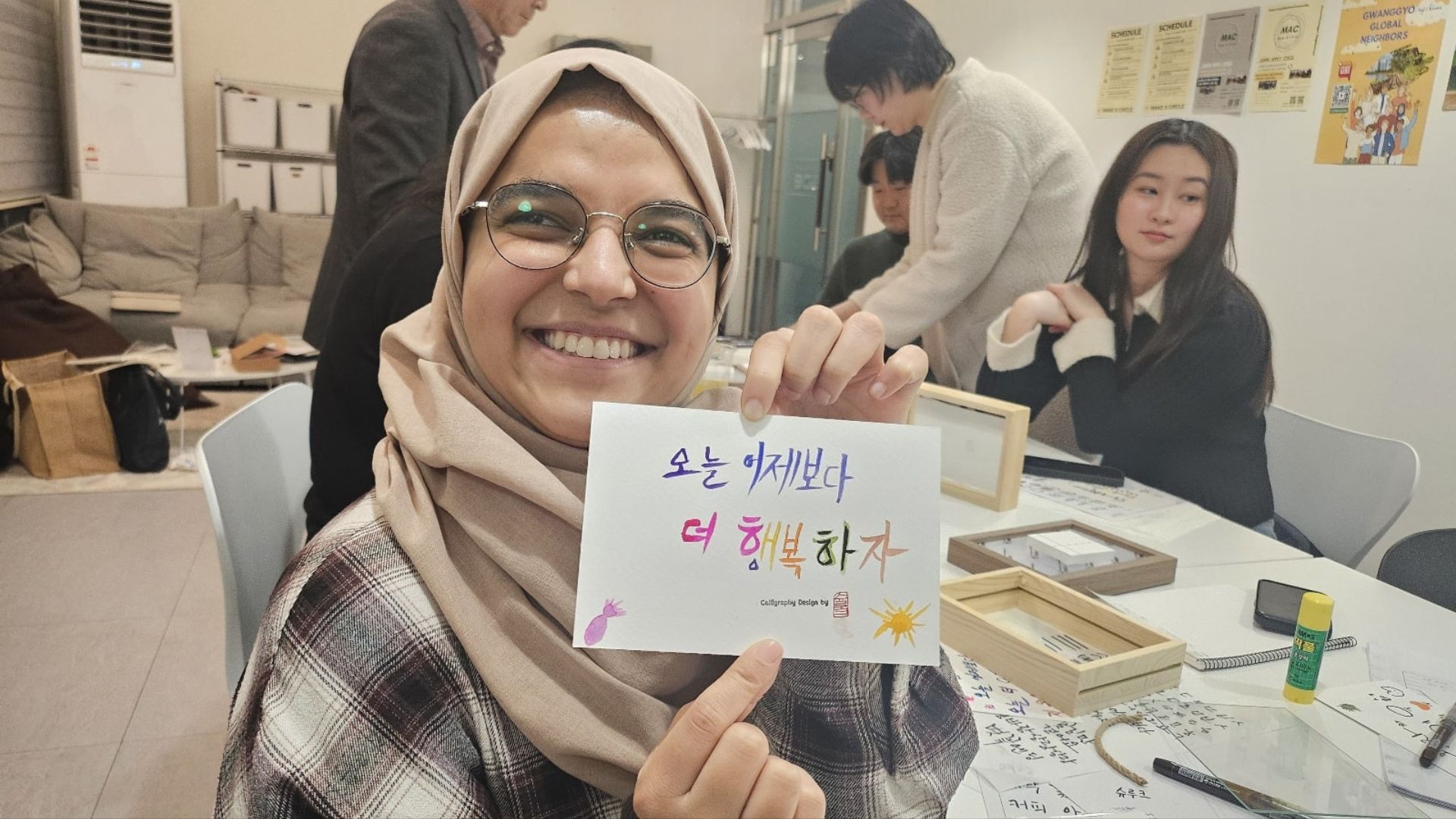 A member showing her calligraphy work